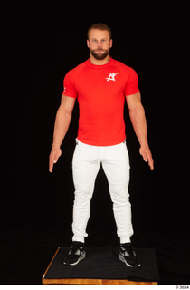 Dave black sneakers dressed red t shirt standing white pants…